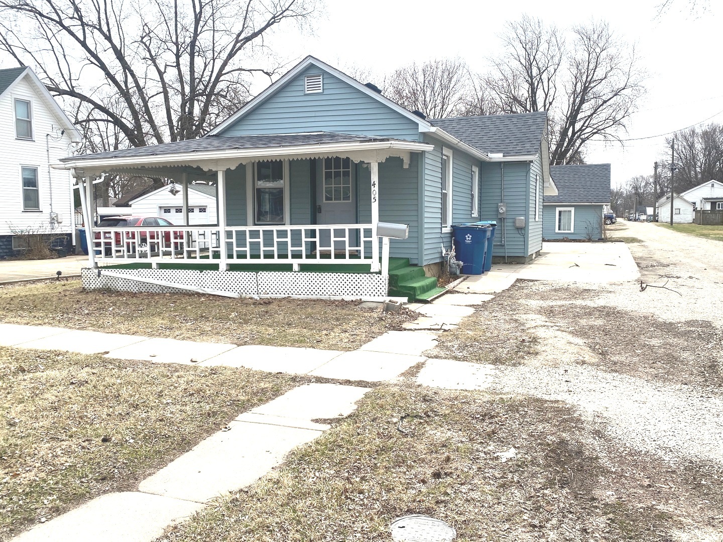 a view of a house with a yard covered in snow