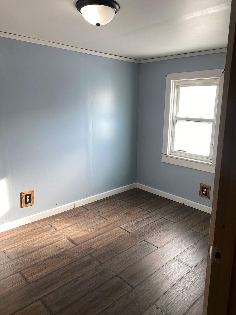 405 6th Street Mendota, IL 61342 - Photo 14 of 21 an empty room with wooden floor and windows