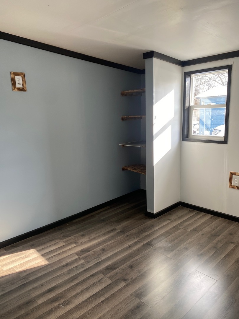 405 6th Street Mendota, IL 61342 - Photo 18 of 21 an empty room with wooden floor and windows