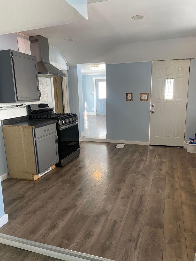 405 6th Street Mendota, IL 61342 - Photo 19 of 21 a view of a kitchen with wooden floor and stainless steel appliances