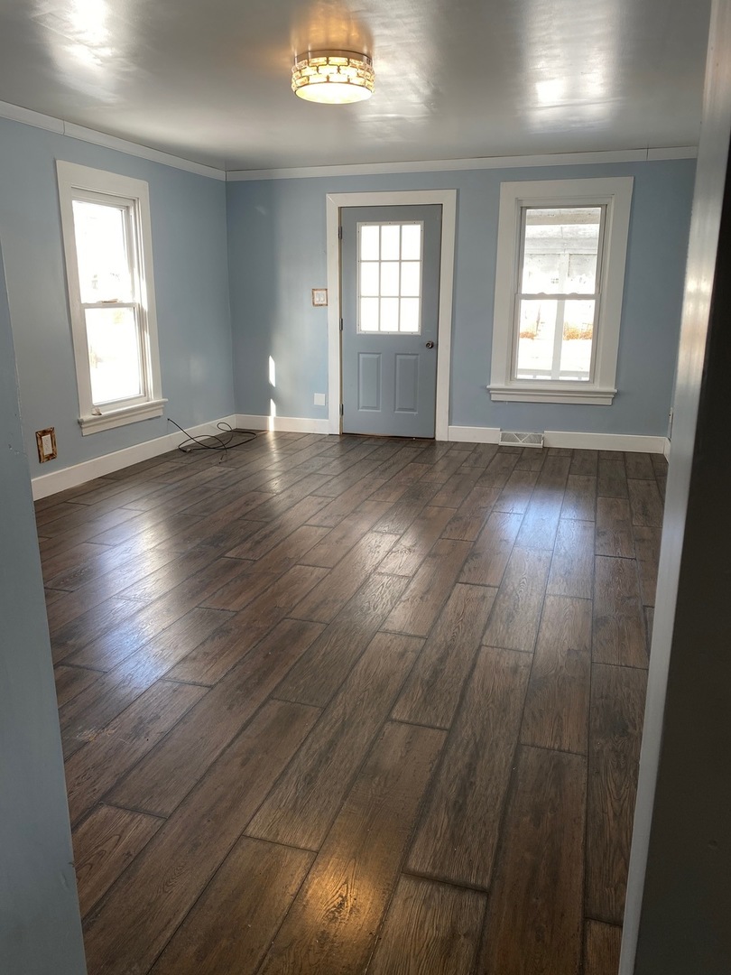 405 6th Street Mendota, IL 61342 - Photo 2 of 21 an empty room with wooden floor and windows