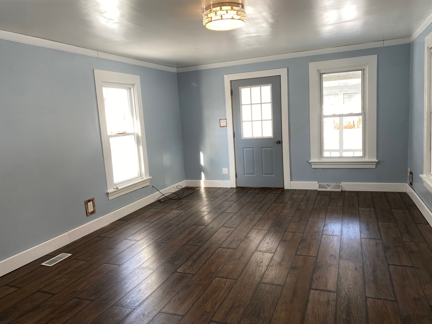 405 6th Street Mendota, IL 61342 - Photo 3 of 21 an empty room with wooden floor and windows