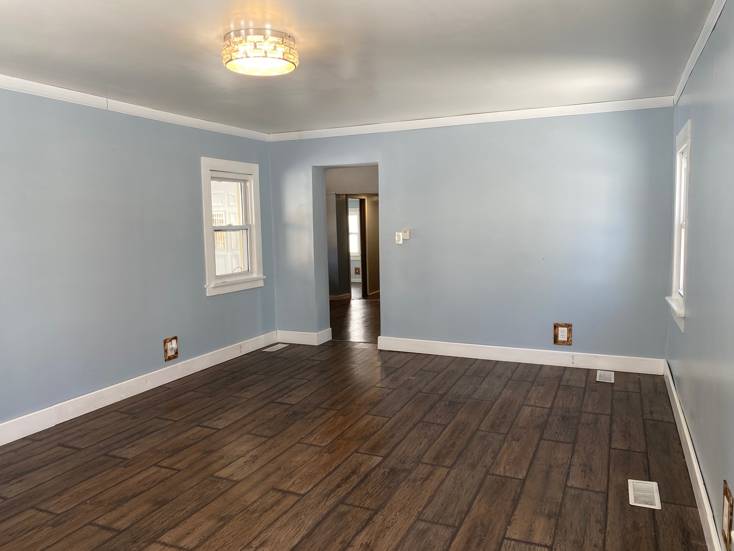 405 6th Street Mendota, IL 61342 - Photo 4 of 21 a view of an empty room with wooden floor and a window