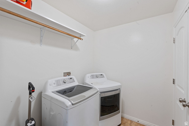 444 South Saddle Road Grantsville, UT 84029 - Photo 7 of 33 Dedicated laundry area featuring white walls, a built-in shelf with a hanging rod, and a white paneled door