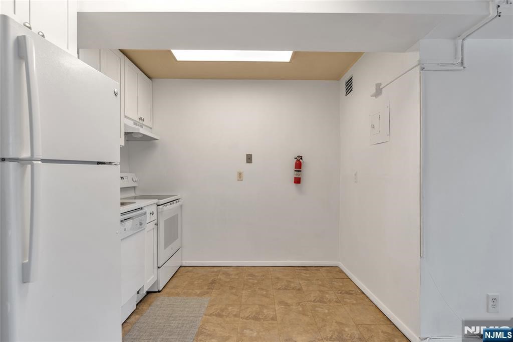 233 12th Street, Unit 3H Palisades Park, NJ 07650 - Photo 7 of 10 a view of cabinets and refrigerator