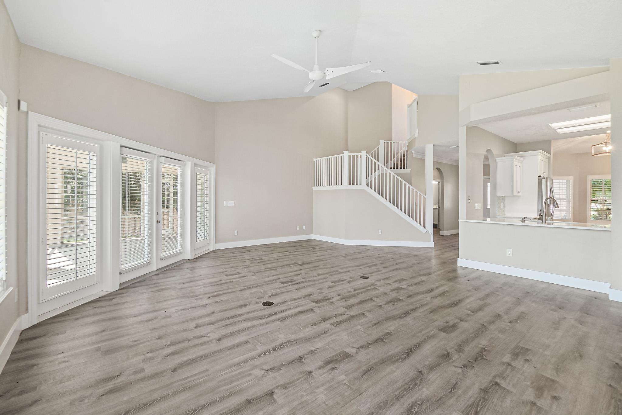 Undisclosed Address St. Augustine, FL 32080 - Photo 12 of 58 a view of an empty room with wooden floor and a kitchen