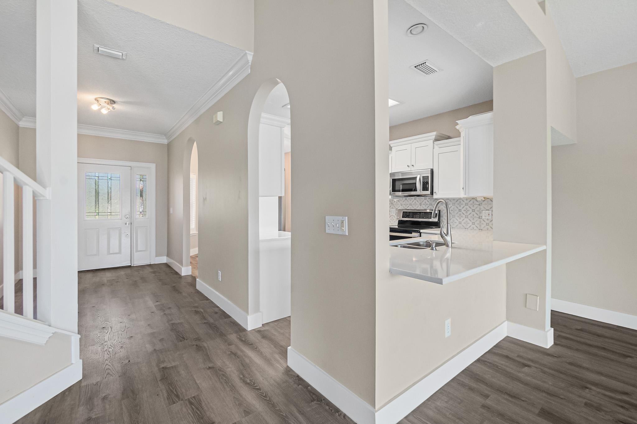 Undisclosed Address St. Augustine, FL 32080 - Photo 15 of 58 a view of a kitchen with a white wooden cabinets and wooden floor