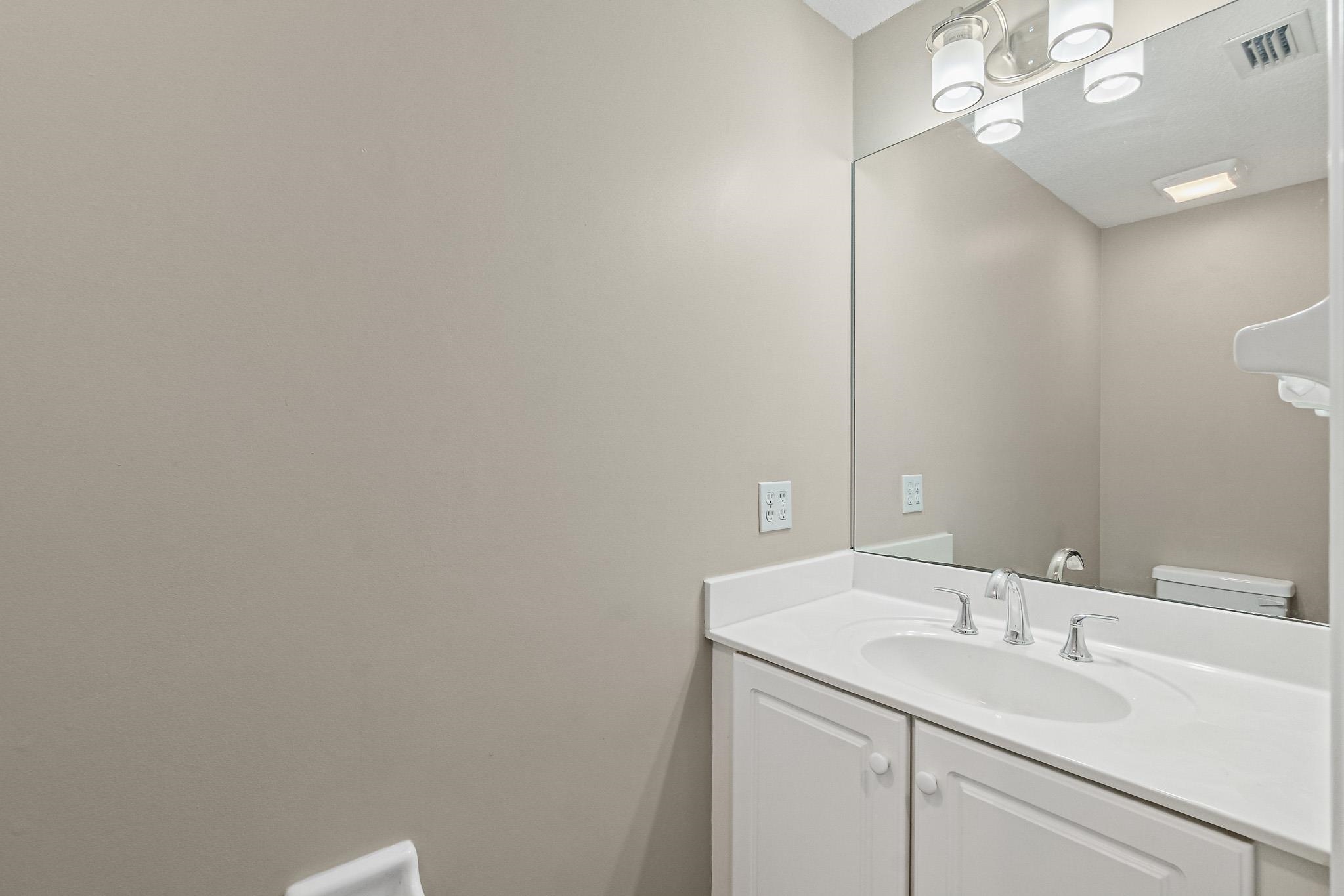 Undisclosed Address St. Augustine, FL 32080 - Photo 29 of 58 a bathroom with a sink vanity and a mirror