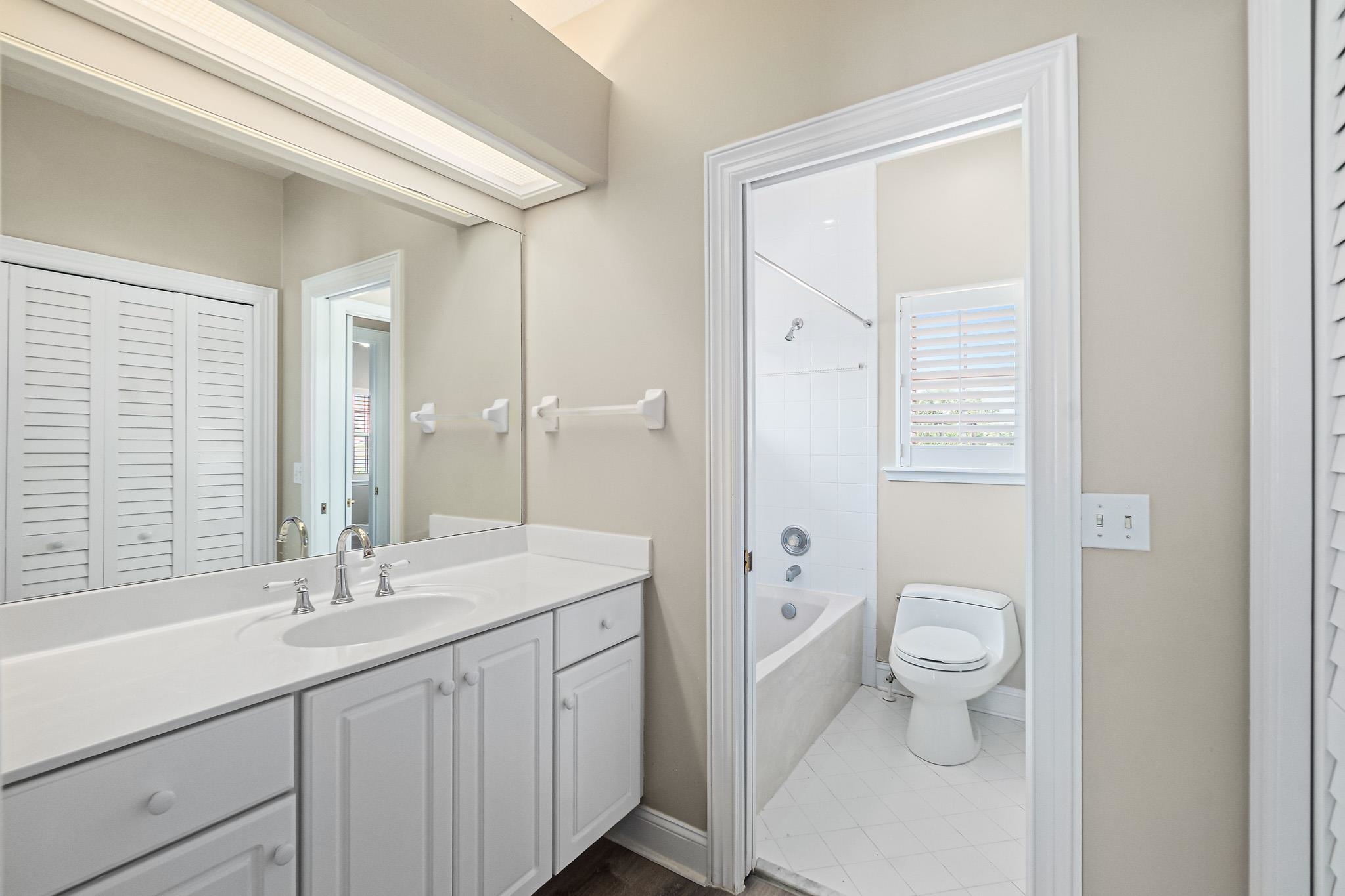 Undisclosed Address St. Augustine, FL 32080 - Photo 38 of 58 a bathroom with a sink a toilet a large mirror and shower