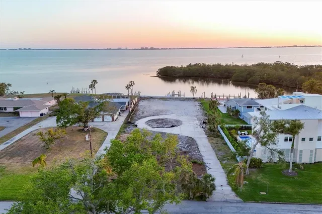 an aerial view of ocean with residential house and outdoor space