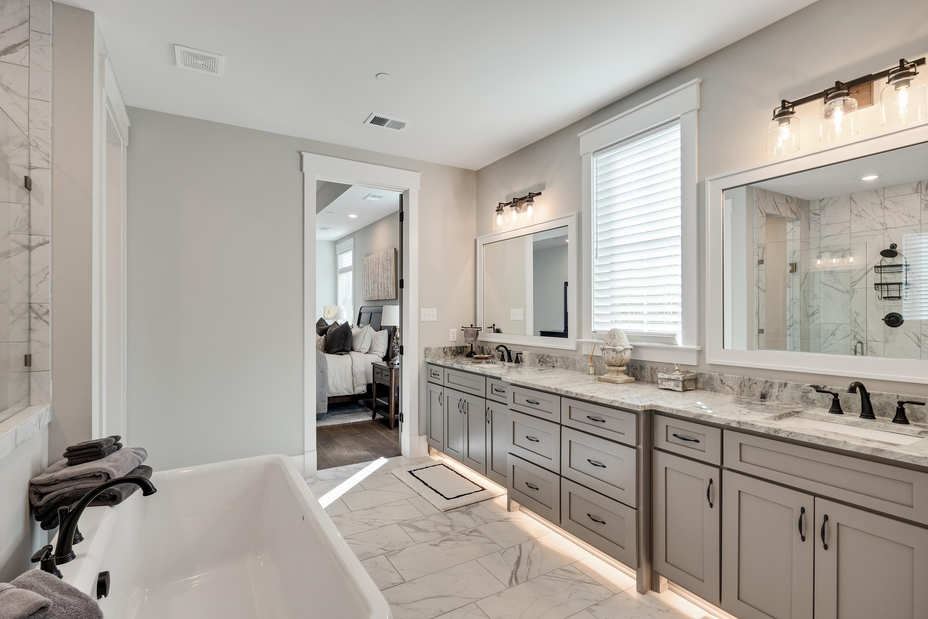 60 Old Pasture Lane Collierville, TN 38017 - Photo 25 of 36 a spacious bathroom with a granite countertop sink a mirror and a bathtub