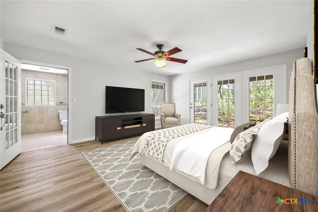 a spacious bathroom with a double vanity sink a large mirror a shower and bathtub