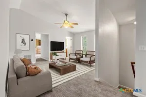 an empty room with windows and ceiling fan