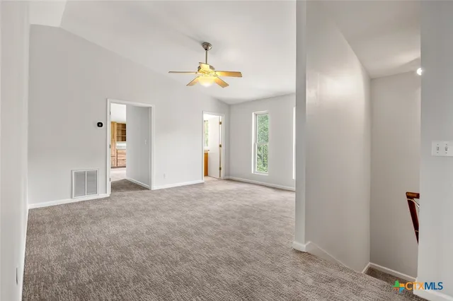 a spacious bedroom with a bed and a cabinet