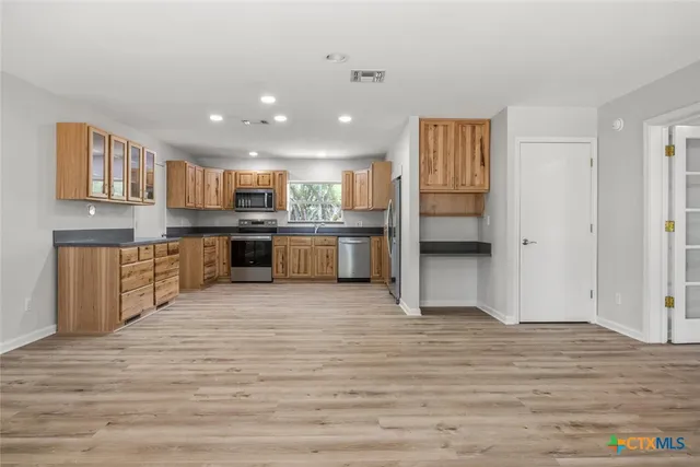 a kitchen with cabinets and appliances