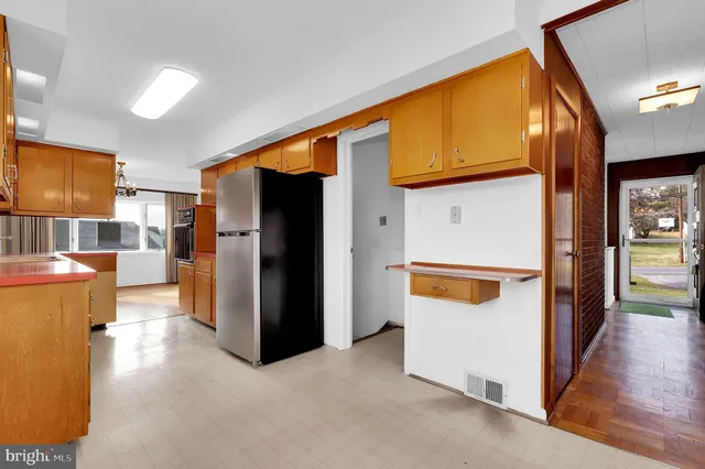 a view of a kitchen with a refrigerator and a stove