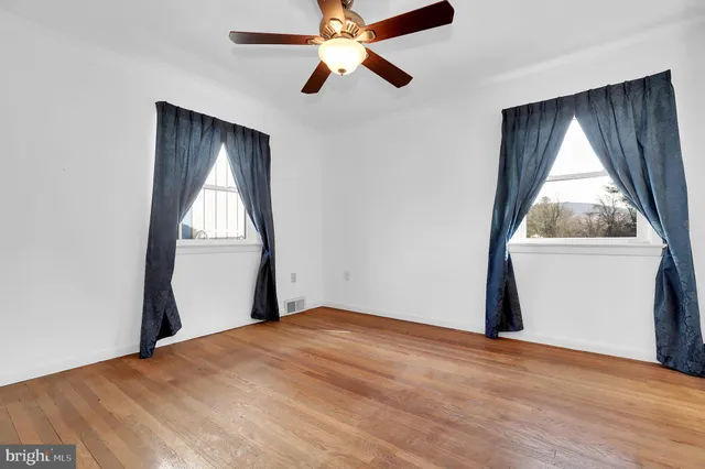 an empty room with windows and closet