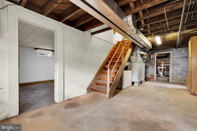 a view of an empty room with staircase