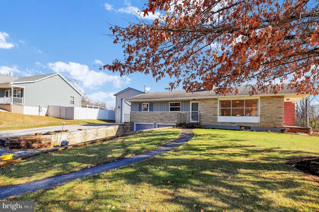 a view of a house with pool and yard