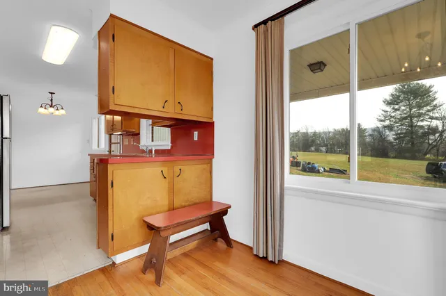 wooden floor in a hall with a window and outside view