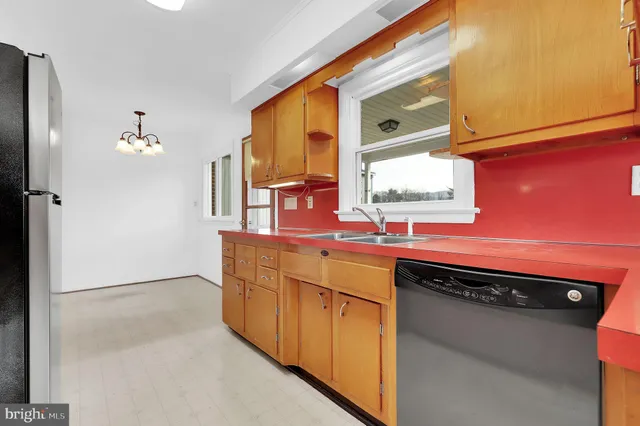 a kitchen with stainless steel appliances a sink and cabinets
