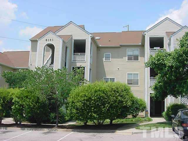 6151 Summer Pointe Place, Unit 202 Raleigh, NC 27606 - Photo 1 of 21 a front view of a house with garden