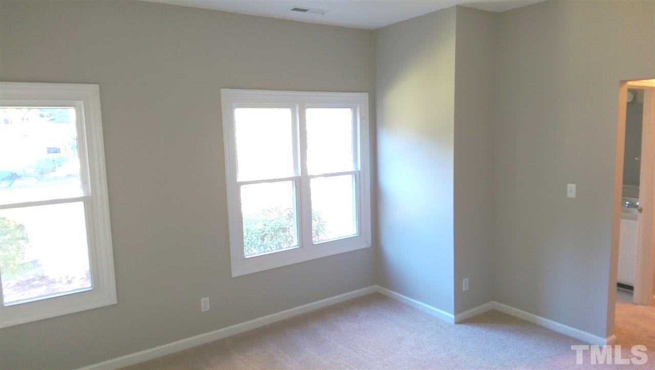 6151 Summer Pointe Place, Unit 202 Raleigh, NC 27606 - Photo 11 of 21 an empty room with windows