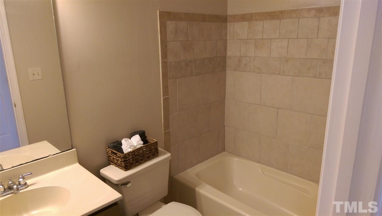 6151 Summer Pointe Place, Unit 202 Raleigh, NC 27606 - Photo 12 of 21 a bathroom with a sink and toilet