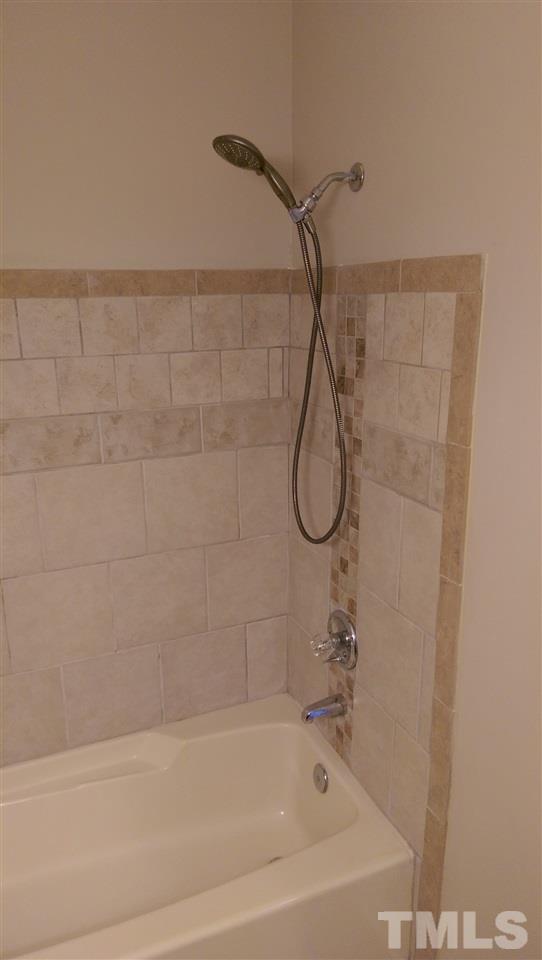 6151 Summer Pointe Place, Unit 202 Raleigh, NC 27606 - Photo 13 of 21 a bathroom with a bath tub with a shower
