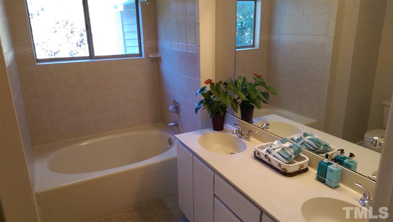 6151 Summer Pointe Place, Unit 202 Raleigh, NC 27606 - Photo 4 of 21 a bath tub sitting next to a white sink