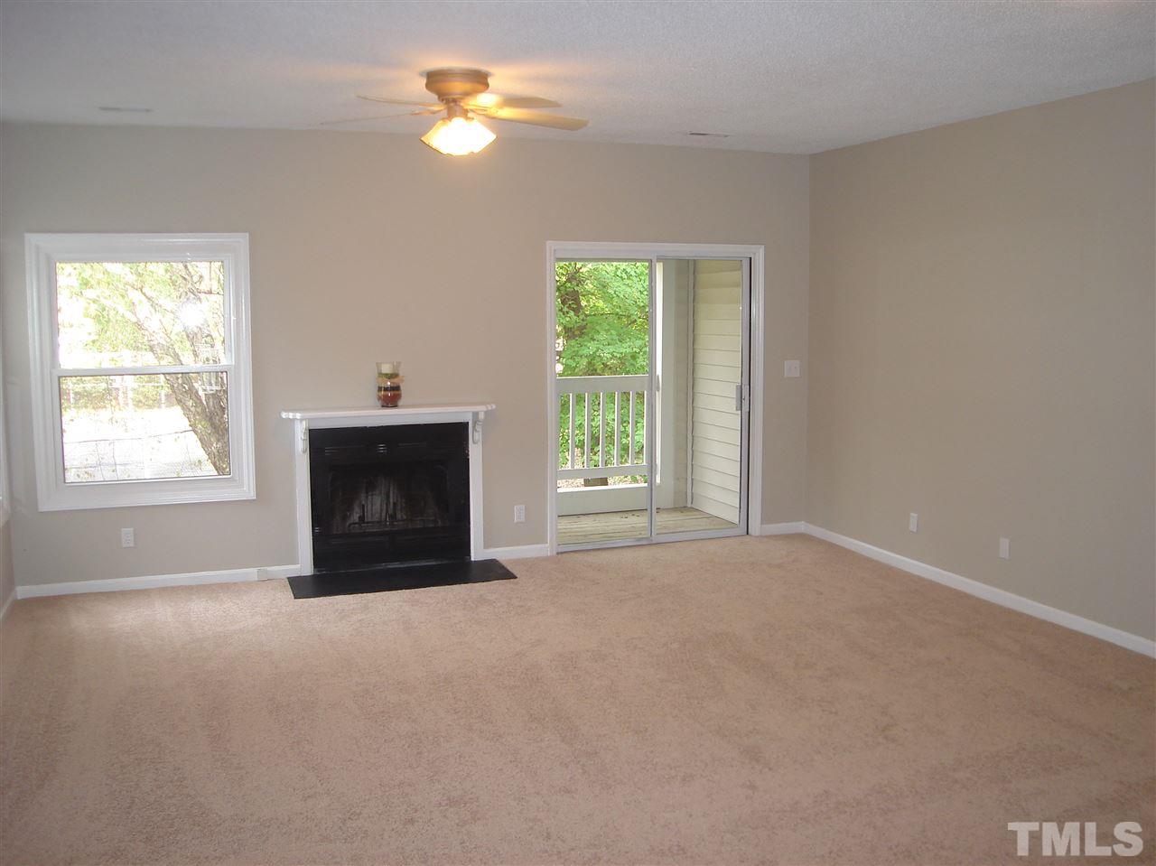 6151 Summer Pointe Place, Unit 202 Raleigh, NC 27606 - Photo 6 of 21 a view of empty room with a fireplace and window