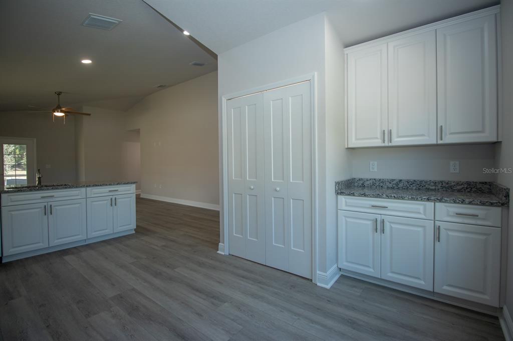 5422 Charles Street New Port Richey, FL 34652 - Photo 11 of 30 a kitchen with wooden floors and cabinets