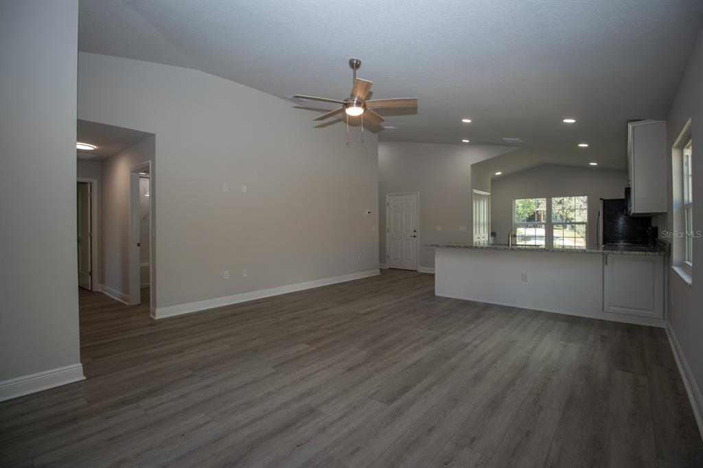 5422 Charles Street New Port Richey, FL 34652 - Photo 14 of 30 wooden floor in an empty room with a window