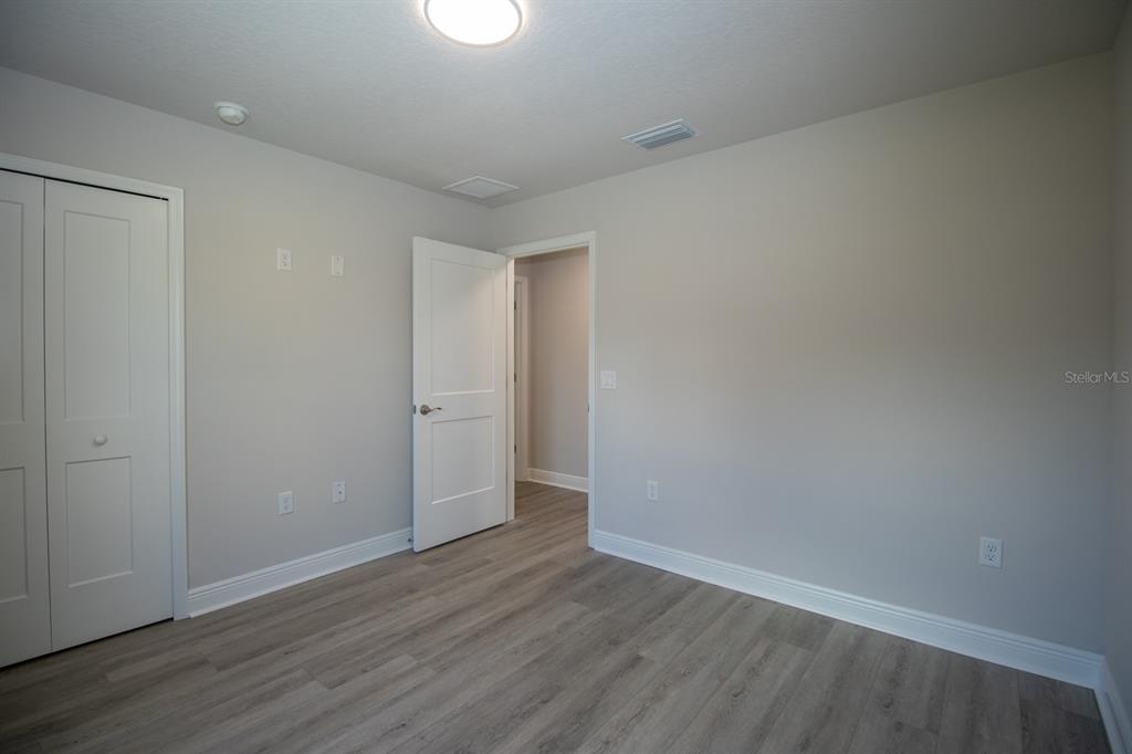 5422 Charles Street New Port Richey, FL 34652 - Photo 19 of 30 a view of an empty room with wooden floor