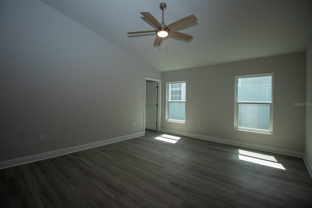 5422 Charles Street New Port Richey, FL 34652 - Photo 22 of 30 a view of an empty room with wooden floor and a window