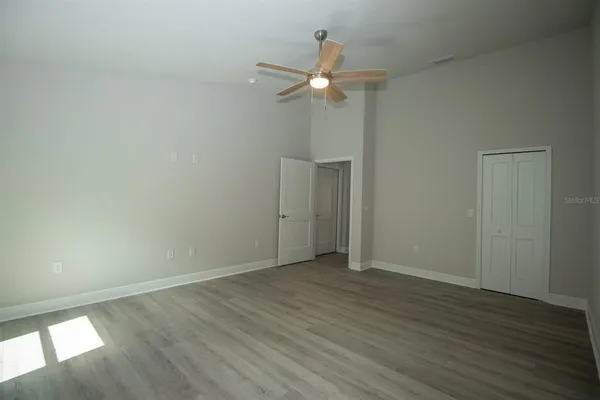 a view of an empty room with wooden floor