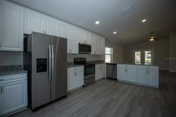 a kitchen with a refrigerator and a sink