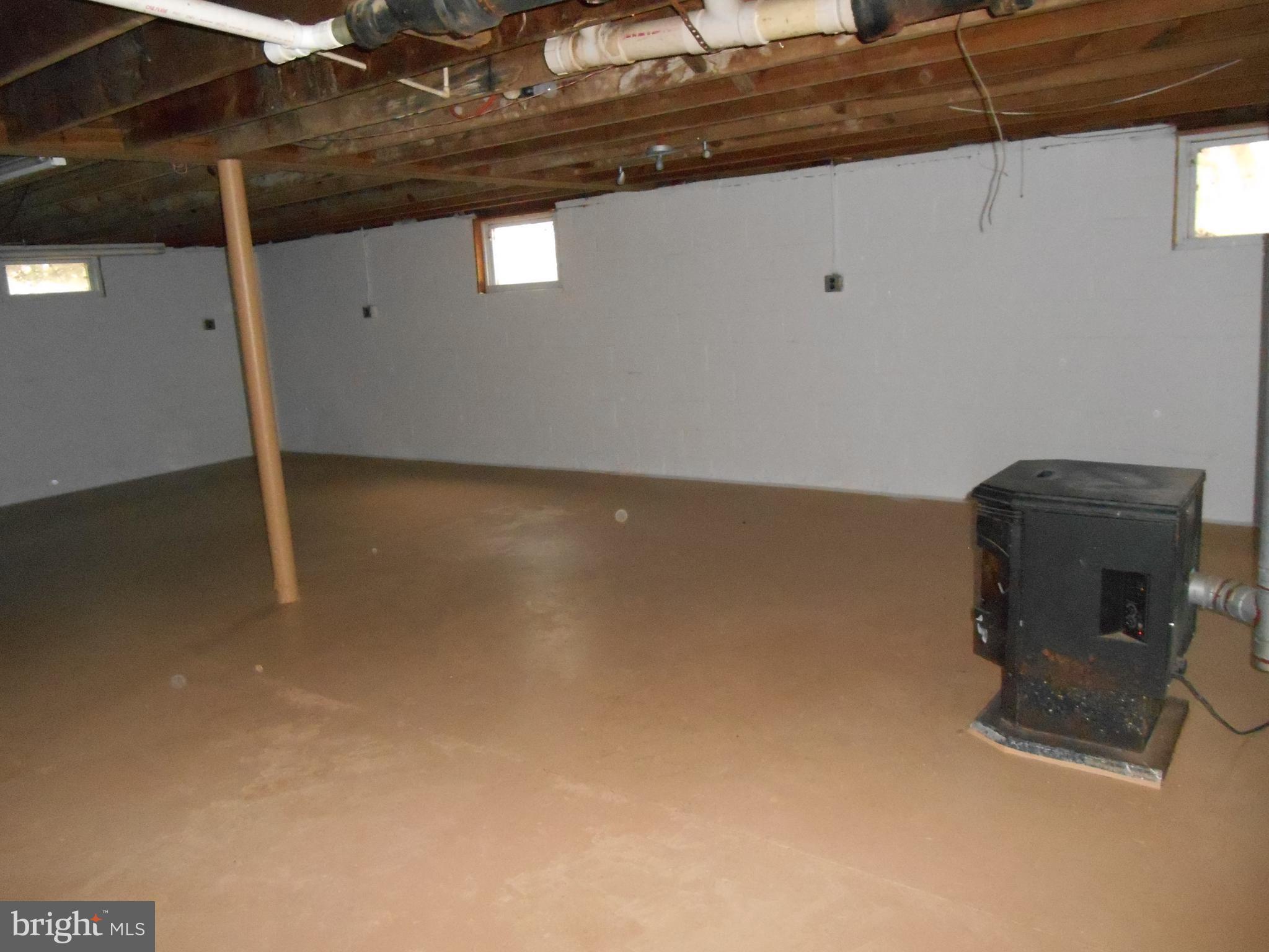 10015 New Bridge Road Denton, MD 21629 - Photo 26 of 30 Living space in basement w/wood stove