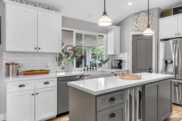 a bathroom with a granite countertop sink a mirror and shower
