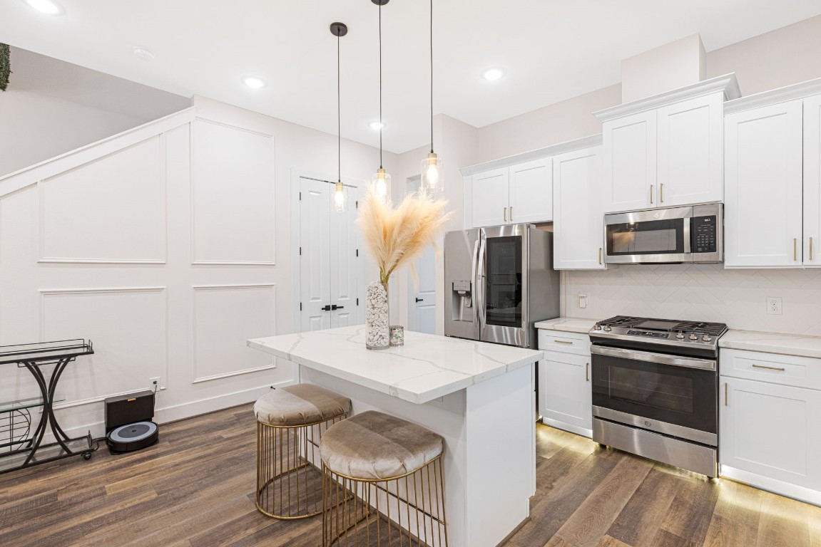 907 Pollard Street, Unit B Houston, TX 77020 - Photo 12 of 30 a kitchen with stainless steel appliances a stove a sink a microwave a refrigerator and cabinets
