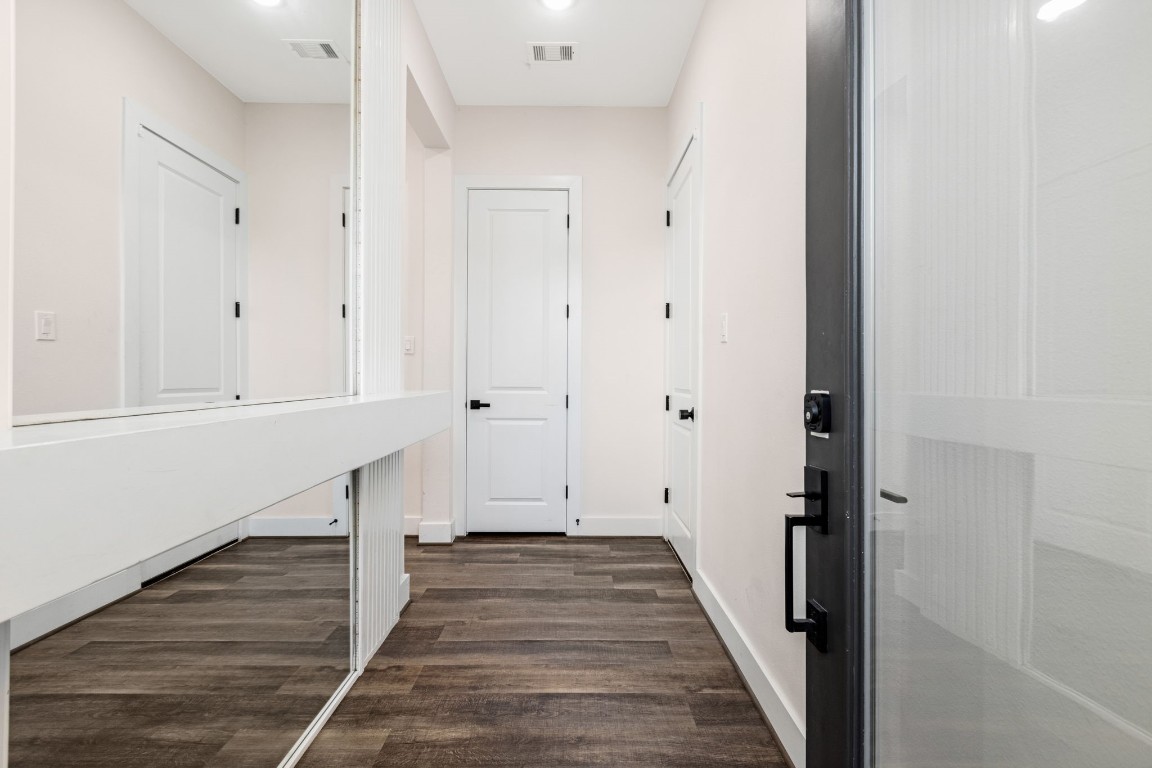 907 Pollard Street, Unit B Houston, TX 77020 - Photo 5 of 30 a view of a hallway with wooden floor and staircase