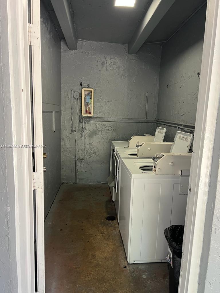 3265 Griffin Road, Unit 101 Dania Beach, FL 33312 - Photo 2 of 4 a utility room with dryer and washer