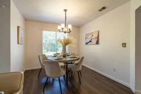 a view of a dining room with furniture wooden floor and chandelier