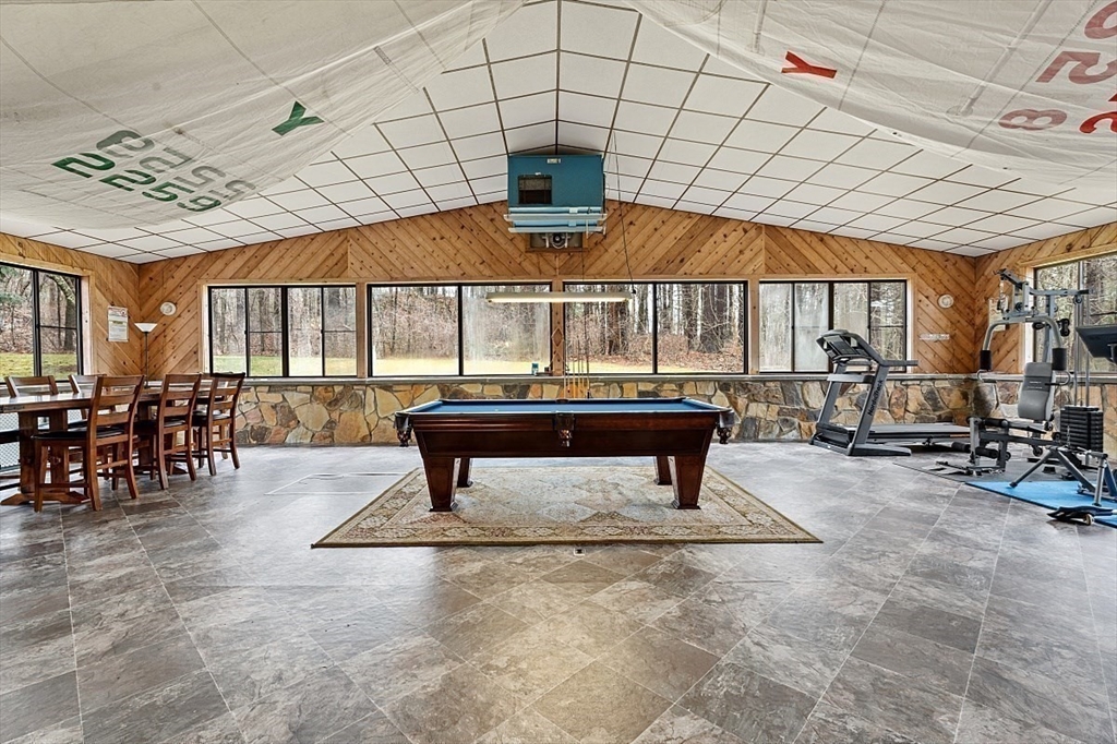 66 Old Right Road Ipswich, MA 01938 - Photo 15 of 36 a living room with a table tennis table and a rug