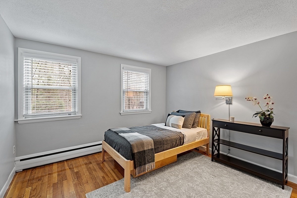 66 Old Right Road Ipswich, MA 01938 - Photo 24 of 36 a bedroom with a bed lamp and window