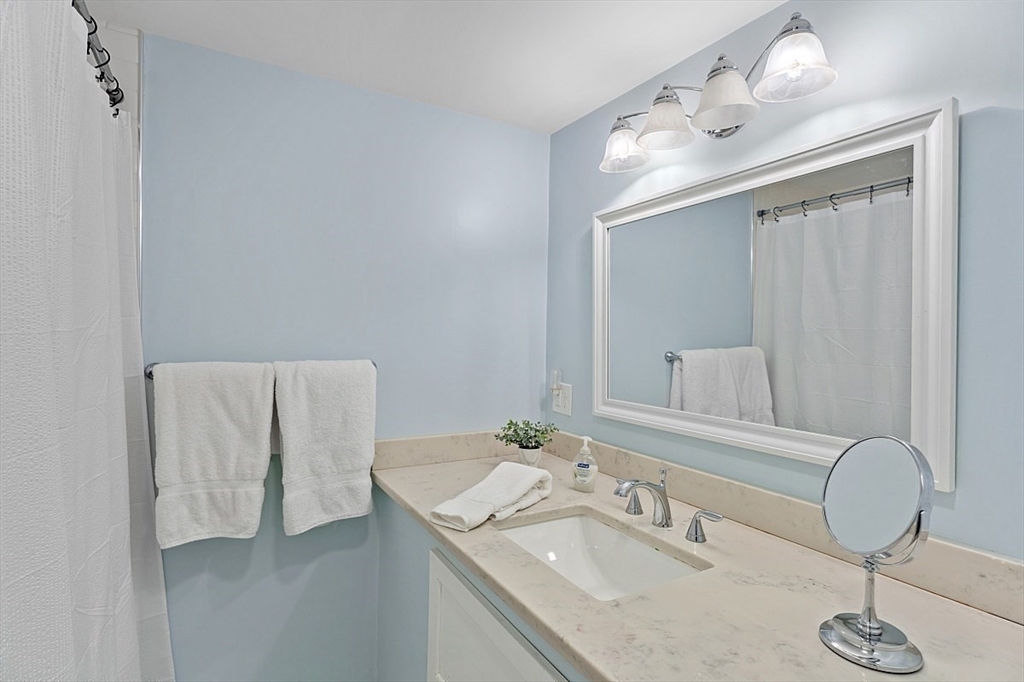 66 Old Right Road Ipswich, MA 01938 - Photo 25 of 36 a bathroom with a granite countertop sink and a mirror