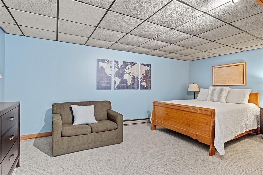 66 Old Right Road Ipswich, MA 01938 - Photo 26 of 36 a bedroom with furniture and a couch