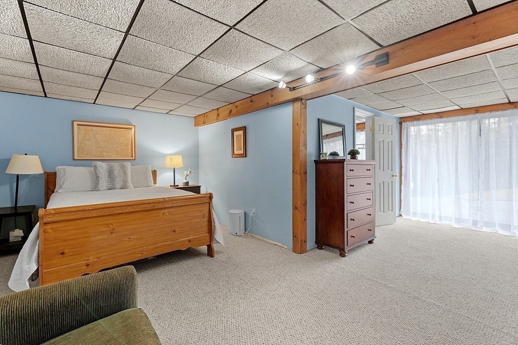 66 Old Right Road Ipswich, MA 01938 - Photo 27 of 36 a bedroom with furniture and a chandelier