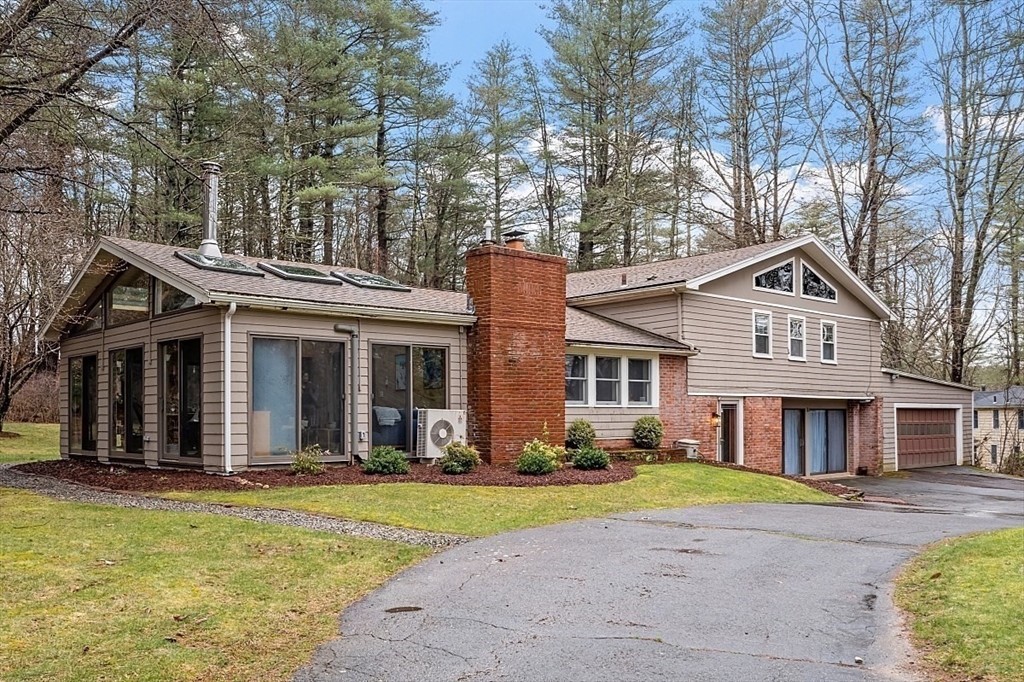 66 Old Right Road Ipswich, MA 01938 - Photo 31 of 36 a front view of a house with a yard and garage