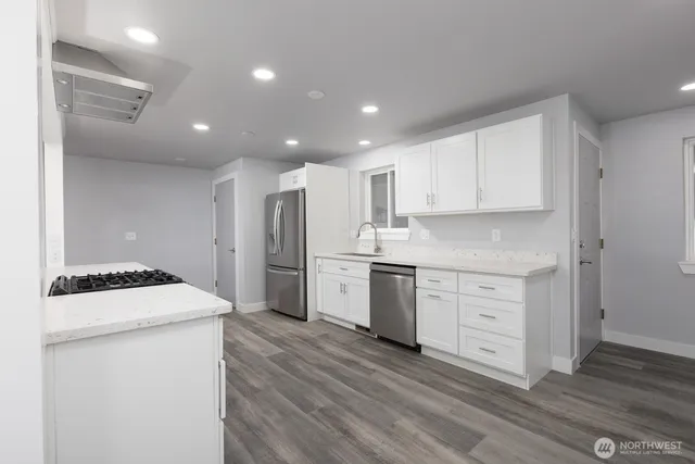 a kitchen with white cabinets and white appliances